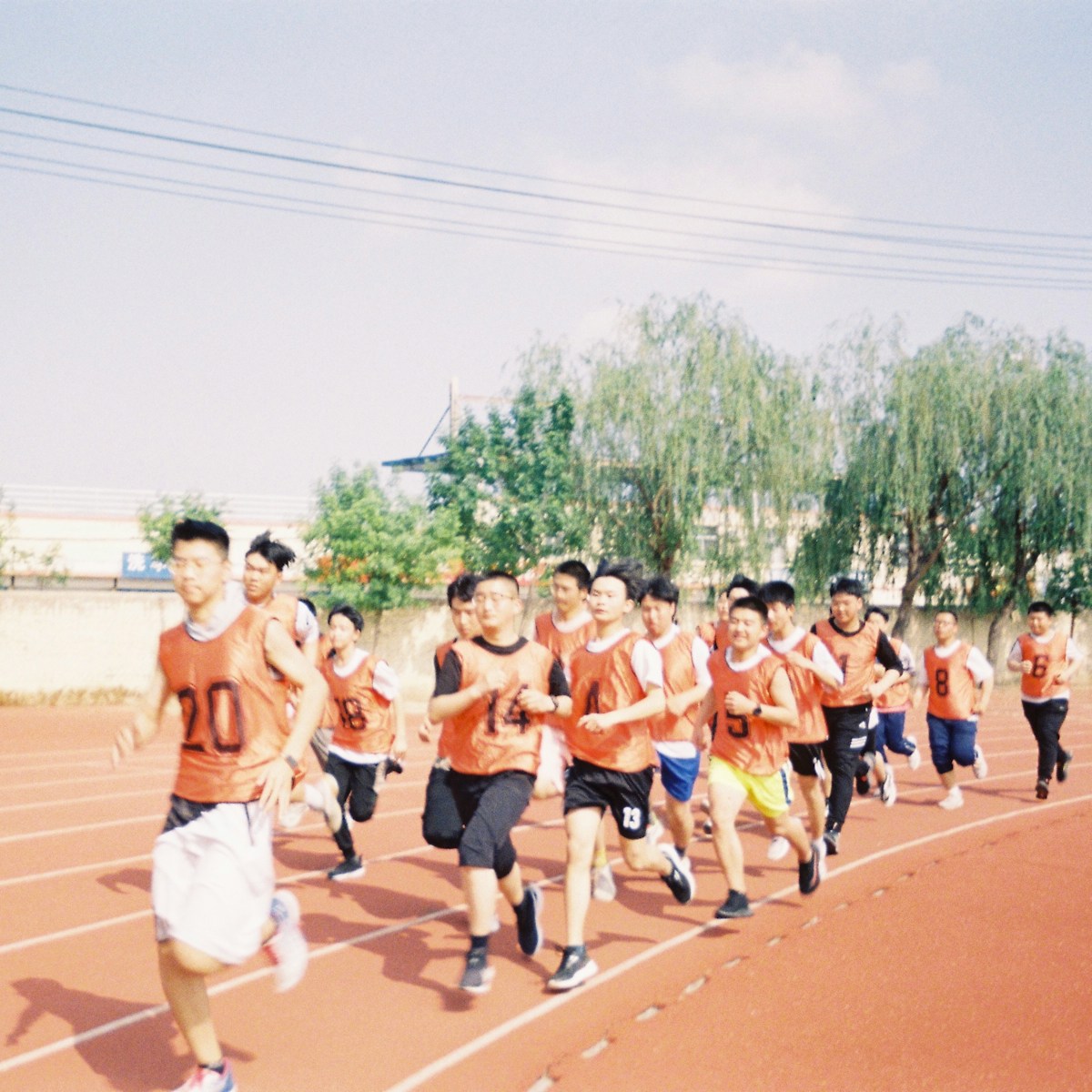 a group of young men running on a track